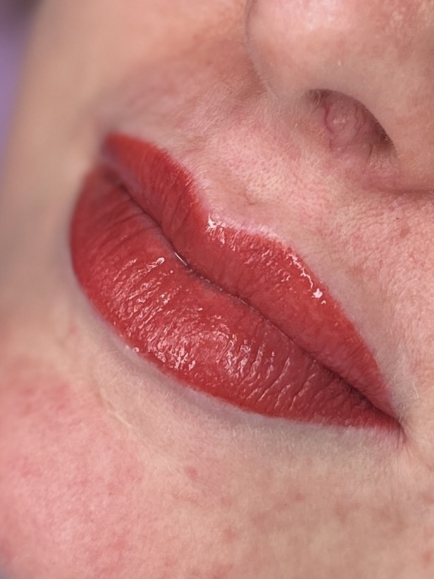 Coral lip blush permanent makeup, close up