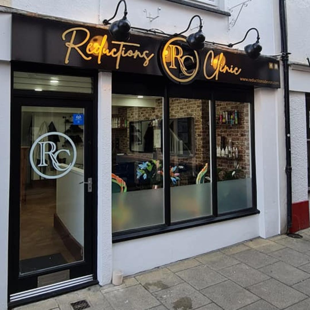 The black and gold shopfront of Reductions Clinic on Holland Street, Barnstaple